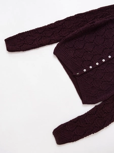 Detail of burgundy openwork lace knit cardigan with intricate diamond texture and buttons