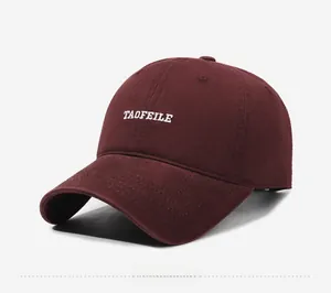 Detailed 45-degree angle view of burgundy baseball cap with white letter embroidery