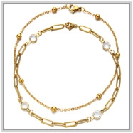 Detail of 18K gold-plated bead chain anklet set with crystal accents and lobster clasp
