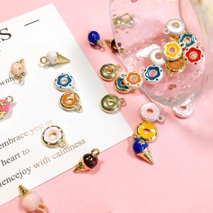 Colorful enamel ice cream and donut charms on pink background for DIY necklace jewelry