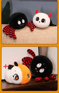 Detail of Halloween plush toys featuring a black spider and a white devil character