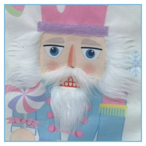 Detail of 3D plush nutcracker embroidery on festive pink fabric Christmas stocking