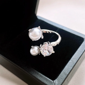 Adjustable silver ring with irregular pearls and cubic zirconia on black velvet