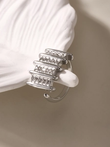 Macro side view of silver layered open ring with sparkling rows of Czech diamonds