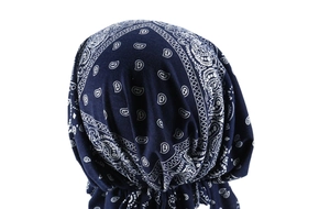 Detail of navy blue pre-tied turban with white paisley print and elastic fabric pleats