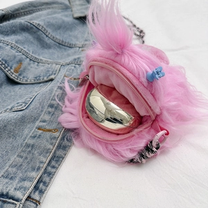 Inner view of pink furry monster crossbody bag showing interior storage capacity
