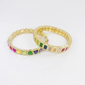 Golden stretch bracelets featuring colorful heart and square cut gemstones in rainbow style