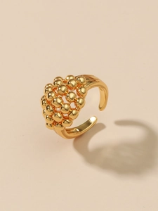 Detail view of gold-plated brass ring with polished ball cluster and open band