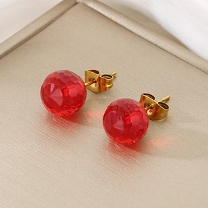Detailed close-up of 12mm faceted red crystal stud earrings with gold titanium steel back