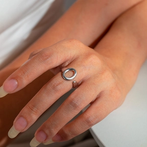 Macro detail of silver fishtail hug ring with adjustable opening and minimalist oval design