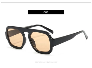 Detail view of vintage black aviator sunglasses with warm amber lenses from a 45-degree angle