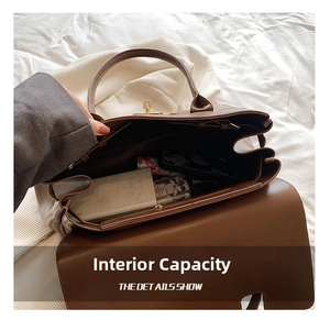 Top view of large brown leather tote interior showing spacious capacity and gold lock