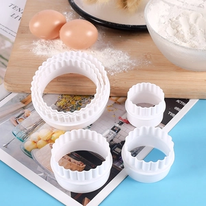 6-piece set of white round fluted cookie cutters on a wooden board for DIY baking
