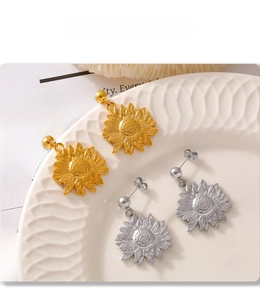 Detailed macro shot of PVD electroplated sunflower earrings in gold and silver finishes
