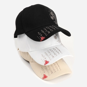 Detail of dragon patterns and Chinese calligraphy prints on cotton baseball caps