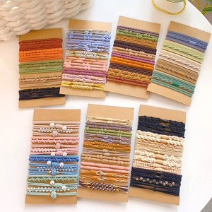 Elastic hair tie set with assorted colors and decorative beads on kraft cards