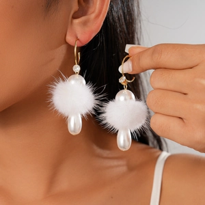 Elegant C-shaped drop earrings featuring white fur pompom, pearl bead and gold hooks