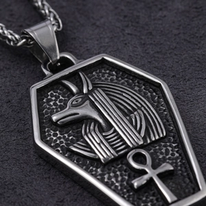 Close-up of stainless steel Anubis and Ankh pendant with vintage etched texture