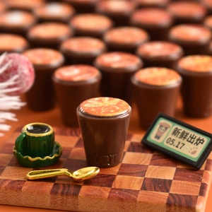 Miniature resin coffee cup with detailed latte art, gold spoon and plaid board