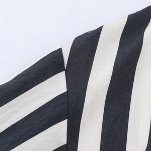 Detailed close-up of shoulder seam and fabric texture on a striped long sleeve shirt