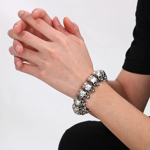 Detail of vintage silver skull bracelet with oxidized steel texture on male wrist