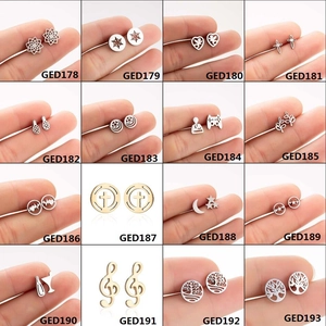 Collection of stainless steel earrings featuring heart and geometric designs in gold and silver