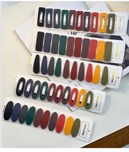 Close-up of matte geometric hair clips in vintage colors on a display card
