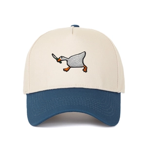 Close-up of goose with knife embroidery on a navy and cream five-panel baseball cap