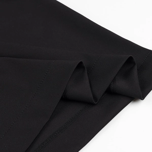 Close-up of the black fabric hem with professional stitching and fine texture details