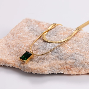 Elegant gold snake chain necklace featuring a rectangular emerald green zircon pendant