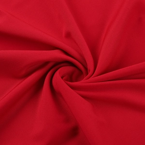 Macro shot of red rib-knit fabric texture with soft drapes and fine vertical stripes