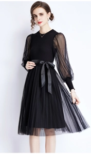 Detail of knit dress with polka dot sheer sleeves and elegant satin bow belt
