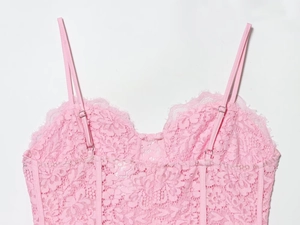 Detailed back view of pink lace camisole showing adjustable straps and floral texture