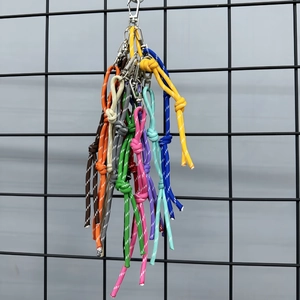 Colorful woven nylon cords with metal lobster clasps and reflective stitching hanging on a grid