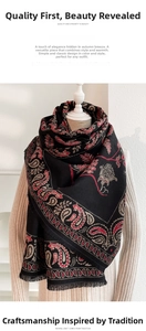 Detailed view of paisley cashmere shawl with red floral patterns and tassel trim