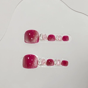 Handmade deep pink cat eye press-on toenails with sparkling glitter and rhinestone details