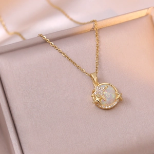 Macro detail of planet pendant with opal stone and zircon stars on a gold chain