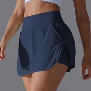 Detail of high-waisted navy tennis skort with functional side pockets and quick-dry fabric