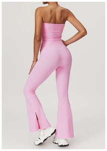 Detailed back view of pink yoga set with flare slit leggings and strapless crop top