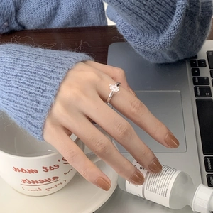 925 Sterling Silver Four-Prong Zircon Ring on a hand holding a coffee cup