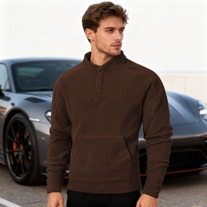 Men's dark brown fleece henley shirt with kangaroo pocket styled in an outdoor setting