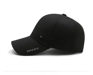 Detail of black baseball cap showing breathable honeycomb fabric and letter embroidery