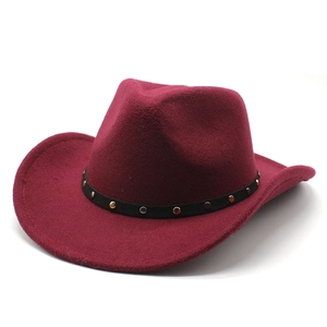 Detail of burgundy wool felt cowboy hat featuring a black studded band and curved brim