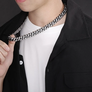 Close-up of hip-hop silver stainless steel Cuban link chain necklace on a male model