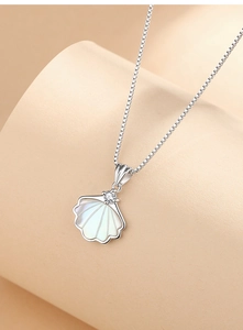 Detailed view of the shell pendant with white mother of pearl and a sparkling gemstone