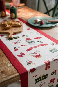 Close-up of Christmas table runner with snowman motifs and Happy Holidays lettering