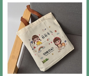 Detail of canvas tote bag with Good Study printing on a soft fabric sofa setting