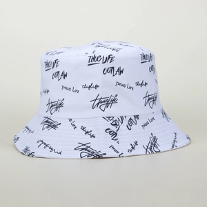 White canvas bucket hat featuring black graffiti letters Thug Life and Outlaw