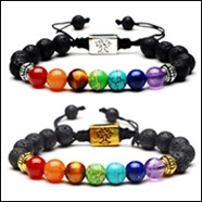 Detail of adjustable chakra lava stone bracelets with metal tree of life charms