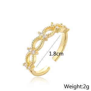 Macro shot of 18K gold plated ring with clear cubic zirconia stones on white mirror background